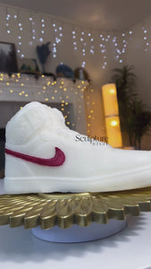 A stylish Nike Jordan 1 high-top shoe-inspired candle wax decor piece, perfect for trendy home accents and fashion-forward interior design. This limited edition collectible features iconic sneaker design elements, making it a unique and artistic statement piece. Ideal for enthusiasts of streetwear and exclusive releases, this decorative item adds flair to any space and makes for a distinctive and fashionable gift.